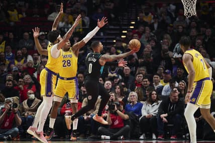 Feb 13, 2023; Portland, Oregon, USA; Portland Trail Blazers guard Damian Lillard (0) drives to the basket during the first half against Los Angeles Lakers forward Anthony Davis (3) and forward Rui Hachimura (28) at Moda Center. Mandatory Credit: Troy Wayrynen-USA TODAY Sports