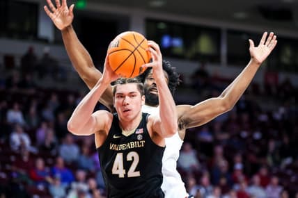 Feb 14, 2023; Columbia, South Carolina, USA; Vanderbilt Commodores forward Quentin Millora-Brown (42) grabs a rebound over South Carolina Gamecocks forward Josh Gray (33) in the first half at Colonial Life Arena. Mandatory Credit: Jeff Blake-USA TODAY Sports