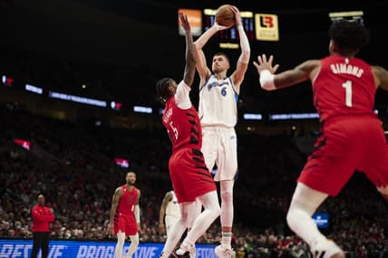 Feb 14, 2023; Portland, Oregon, USA; Washington Wizards center Kristaps Porzingis (6) shoots a jump shot during the first half against Portland Trail Blazers forward Cam Reddish (5) at Moda Center. Mandatory Credit: Troy Wayrynen-USA TODAY Sports