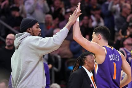 Feb 14, 2023; Phoenix, Arizona, USA; Phoenix Suns forward Kevin Durant slaps hands with Phoenix Suns guard Devin Booker (1) during the second half of the game against the Sacramento Kings at Footprint Center. Mandatory Credit: Joe Camporeale-USA TODAY Sports