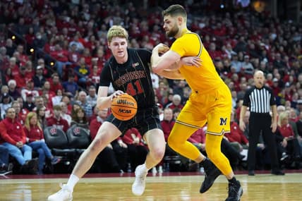 Feb 14, 2023; Madison, Wisconsin, USA;  Wisconsin Badgers forward Steven Crowl (41) drives to the basket under coverage by Michigan Wolverines center Hunter Dickinson (1) during the second half at the Kohl Center. Mandatory Credit: Kayla Wolf-USA TODAY Sports