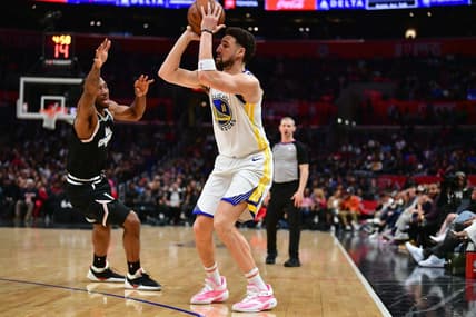 Feb 14, 2023; Los Angeles, California, USA; Golden State Warriors guard Klay Thompson (11) shoots against Los Angeles Clippers forward Kawhi Leonard (2) during the second half at Crypto.com Arena. Mandatory Credit: Gary A. Vasquez-USA TODAY Sports