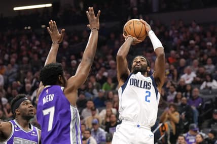 Feb 11, 2023; Sacramento, California, USA; Dallas Mavericks guard Kyrie Irving (2) shoots against Sacramento Kings forward Chimezie Metu (7) during the second quarter at Golden 1 Center. Mandatory Credit: Darren Yamashita-USA TODAY Sports