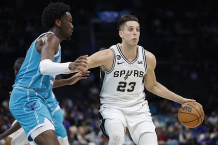 Feb 15, 2023; Charlotte, North Carolina, USA; San Antonio Spurs forward Zach Collins (23) runs the offense against Charlotte Hornets center Mark Williams (5) during the first half at Spectrum Center. Mandatory Credit: Nell Redmond-USA TODAY Sports