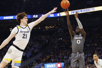 Feb 15, 2023; Milwaukee, Wisconsin, USA;  Xavier Musketeers guard Souley Boum (0) shoots against Marquette Golden Eagles forward Ben Gold (21) during the first half at Fiserv Forum. Mandatory Credit: Jeff Hanisch-USA TODAY Sports
