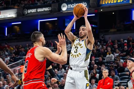 Feb 15, 2023; Indianapolis, Indiana, USA; Indiana Pacers guard Chris Duarte (3) passes the ball while Chicago Bulls center Nikola Vucevic (9) defends in the second quarter at Gainbridge Fieldhouse. Mandatory Credit: Trevor Ruszkowski-USA TODAY Sports