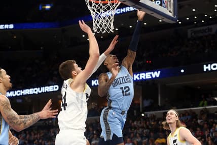 Feb 15, 2023; Memphis, Tennessee, USA; Memphis Grizzlies guard Ja Morant (12) shoots as Utah Jazz center Walker Kessler (24) defends during the first half at FedExForum. Mandatory Credit: Petre Thomas-USA TODAY Sports