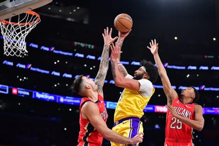 Feb 15, 2023; Los Angeles, California, USA; Los Angeles Lakers forward Anthony Davis (3) moves to the basket against New Orleans Pelicans center Willy Hernangomez (9) and guard Trey Murphy III (25) during the first half at Crypto.com Arena. Mandatory Credit: Gary A. Vasquez-USA TODAY Sports