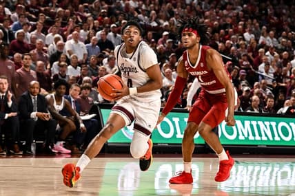 Feb 15, 2023; College Station, Texas, USA; Texas A&M Aggies guard Wade Taylor IV (4) drives through Arkansas Razorbacks guard Ricky Council IV (1) during the second half at Reed Arena. Mandatory Credit: Maria Lysaker-USA TODAY Sports