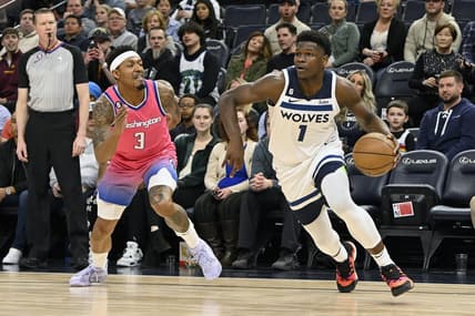 Feb 16, 2023; Minneapolis, Minnesota, USA;  Minnesota Timberwolves guard Anthony Edwards (1) goes baseline as Washington Wizzards guard Bradley Beal (3) gives chase during the first quarter at Target Center. Mandatory Credit: Nick Wosika-USA TODAY Sports