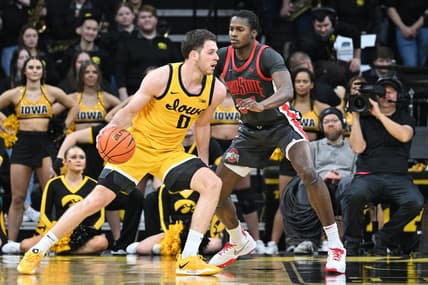 Feb 16, 2023; Iowa City, Iowa, USA; Iowa Hawkeyes forward Filip Rebraca (0) controls the ball as Ohio State Buckeyes center Felix Okpara (34) defends during the first half at Carver-Hawkeye Arena. Mandatory Credit: Jeffrey Becker-USA TODAY Sports