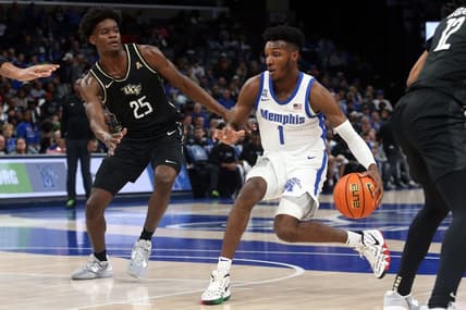 Feb 16, 2023; Memphis, Tennessee, USA; Memphis Tigers guard Keonte Kennedy (1) dribbles as UCF Knights forward Taylor Hendricks (25) defends during the first half at FedExForum. Mandatory Credit: Petre Thomas-USA TODAY Sports