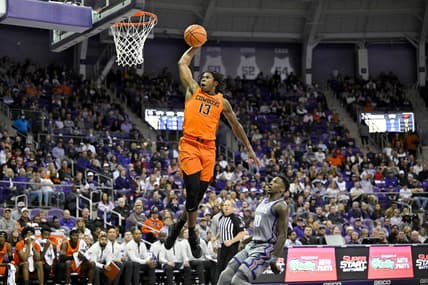 Feb 18, 2023; Fort Worth, Texas, USA; Oklahoma State Cowboys guard Quion Williams (13) dunks the ball as TCU Horned Frogs guard Damion Baugh (10) looks on during the second half at the Ed and Rae Schollmaier Arena. Mandatory Credit: Jerome Miron-USA TODAY Sports