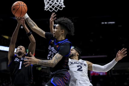 Feb 18, 2023; Cincinnati, Ohio, USA;  DePaul Blue Demons guard Caleb Murphy (middle), forward Javan Johnson (left), and Xavier Musketeers forward Jerome Hunter battle for a rebound in the first half at the Cintas Center. Mandatory Credit: Aaron Doster-USA TODAY Sports