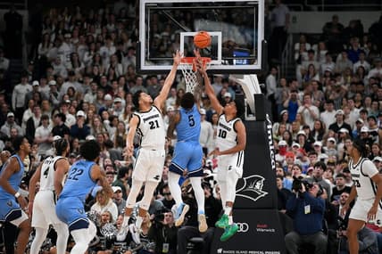 Feb 18, 2023; Providence, Rhode Island, USA;  Providence Friars forward Clifton Moore (21) and Providence Friars guard Noah Locke (10) defend the basket from Villanova Wildcats guard Justin Moore (5) during the first half at Amica Mutual Pavilion. Mandatory Credit: Eric Canha-USA TODAY Sports