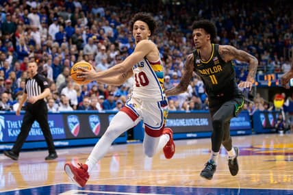 Feb 18, 2023; Lawrence, Kansas, USA; Kansas Jayhawks forward Jalen Wilson (10) drives to the basket around Baylor Bears forward Jalen Bridges (11) during the second half at Allen Fieldhouse. Mandatory Credit: William Purnell-USA TODAY Sports
