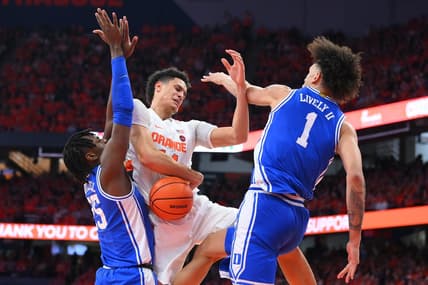 Feb 18, 2023; Syracuse, New York, USA; Syracuse Orange center Jesse Edwards (14) loses control of the ball as Duke Blue Devils forward Mark Mitchell (25) and center Dereck Lively II (1) defend during the first half at the JMA Wireless Dome. Mandatory Credit: Rich Barnes-USA TODAY Sports