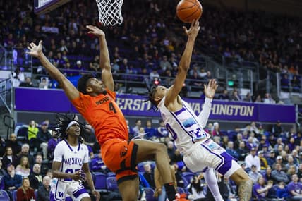 Feb 18, 2023; Seattle, Washington, USA; Washington Huskies guard Koren Johnson (0) puts up a shot following a foul by Oregon State Beavers guard Dexter Akanno (4) during the first half at Alaska Airlines Arena at Hec Edmundson Pavilion. Mandatory Credit: Joe Nicholson-USA TODAY Sports