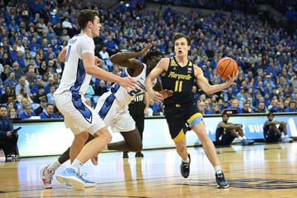Feb 21, 2023; Omaha, Nebraska, USA;  Marquette Golden Eagles guard Tyler Kolek (11) drives against Creighton Bluejays center Ryan Kalkbrenner (11) in the first half at CHI Health Center Omaha. Mandatory Credit: Steven Branscombe-USA TODAY Sports
