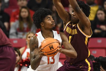 Feb 22, 2023; College Park, Maryland, USA;  13 makes a move to the basket on Minnesota Golden Gophers forward Joshua Ola-Joseph (1) during the first half at Xfinity Center. Mandatory Credit: Tommy Gilligan-USA TODAY Sports