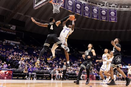 Feb 22, 2023; Baton Rouge, Louisiana, USA; LSU Tigers guard Cam Hayes (1) has a shot blocked by Vanderbilt Commodores guard Jordan Wright (4) during the first half at Pete Maravich Assembly Center. Mandatory Credit: Stephen Lew-USA TODAY Sports