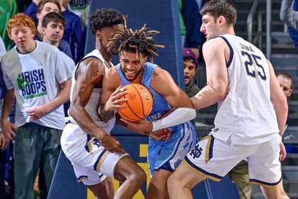 Feb 22, 2023; South Bend, Indiana, USA; North Carolina Tar Heels guard RJ Davis (4) is fouled by Notre Dame Fighting Irish forward Matt Zona (25) during the first half at the Purcell Pavilion. Mandatory Credit: Matt Cashore-USA TODAY Sports