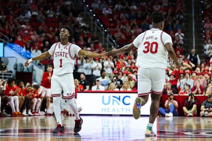 Feb 22, 2023; Raleigh, North Carolina, USA; North Carolina State Wolfpack forward D.J. Burns Jr. (30) and guard Jarkel Joiner (1) celebrate during the first half against Wake Forest Demon Deacons at PNC Arena. Mandatory Credit: Jaylynn Nash-USA TODAY Sports