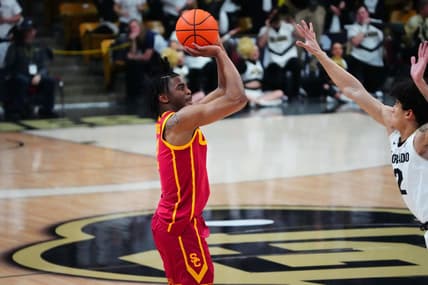 Feb 23, 2023; Boulder, Colorado, USA; USC Trojans guard Reese Dixon-Waters (2) lines up a three point basket over Colorado Buffaloes guard KJ Simpson (2) in the first half at the CU Events Center. Mandatory Credit: Ron Chenoy-USA TODAY Sports