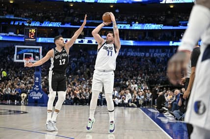 Feb 23, 2023; Dallas, Texas, USA; Dallas Mavericks guard Luka Doncic (77) shoots over San Antonio Spurs forward Doug McDermott (17) during the second quarter at the American Airlines Center. Mandatory Credit: Jerome Miron-USA TODAY Sports