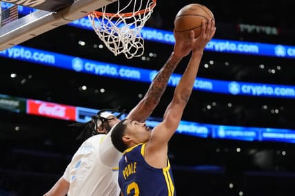 Feb 23, 2023; Los Angeles, California, USA; Golden State Warriors guard Jordan Poole (left) drives to the net against Los Angeles Lakers forward Anthony Davis in the first half at Crypto.com Arena. Mandatory Credit: Kirby Lee-USA TODAY Sports