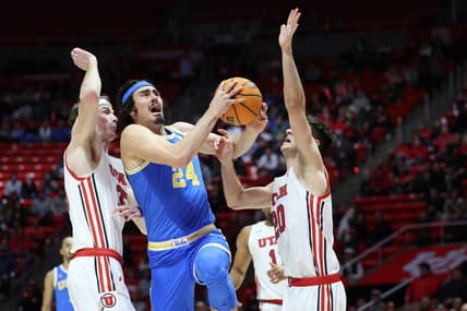 Feb 23, 2023; Salt Lake City, Utah, USA; UCLA Bruins guard Jaime Jaquez Jr. (24) drives between Utah Utes center Branden Carlson (35) and guard Lazar Stefanovic (20) in the first half at Jon M. Huntsman Center. Mandatory Credit: Rob Gray-USA TODAY Sports