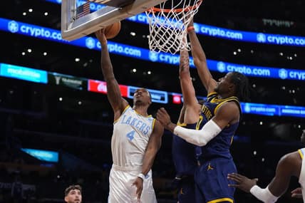 Feb 23, 2023; Los Angeles, California, USA; Los Angeles Lakers guard Lonnie Walker IV (4) shoots the ball against Golden State Warriors forward Anthony Lamb (40) and forward Jonathan Kuminga (00) in the second half at Crypto.com Arena. Mandatory Credit: Kirby Lee-USA TODAY Sports