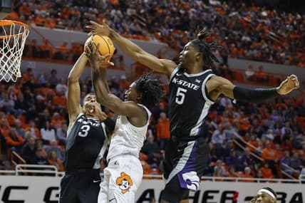 Feb 25, 2023; Stillwater, Oklahoma, USA; Oklahoma State Cowboys guard John-Michael Wright (51) goes up for a basket between Kansas State Wildcats forward David N'Guessan (3) and guard Cam Carter (5) during the first half at Gallagher-Iba Arena. Mandatory Credit: Alonzo Adams-USA TODAY Sports