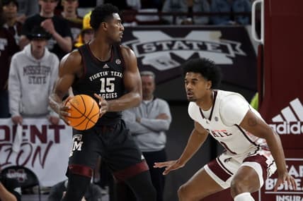 Feb 25, 2023; Starkville, Mississippi, USA; Texas A&M Aggies forward Henry Coleman III (15) handles the ball as Mississippi State Bulldogs forward Tolu Smith (1) defends during the first half at Humphrey Coliseum. Mandatory Credit: Petre Thomas-USA TODAY Sports