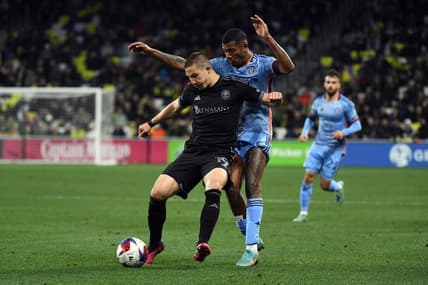 Feb 25, 2023; Nashville, Tennessee, USA;  Nashville SC midfielder Alex Muyl (19) and New York City FC forward Thiago (8) battle for the ball in the second half at Geodis Park. Mandatory Credit: Christopher Hanewinckel-USA TODAY Sports