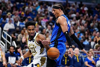 Feb 25, 2023; Orlando, Florida, USA; Indiana Pacers forward Aaron Nesmith (23) dribbles the ball against Orlando Magic forward Paolo Banchero (5) during the second quarter at Amway Center. Mandatory Credit: Rich Storry-USA TODAY Sports