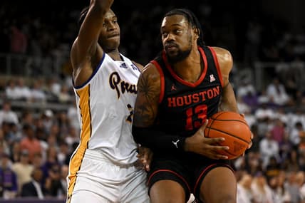 Feb 25, 2023; Greenville, North Carolina, USA;  Houston Cougars forward J'Wan Roberts (13) drives against East Carolina Pirates forward Ezra Ausar (2) during the first half at Williams Arena at Minges Coliseum. Mandatory Credit: William Howard-USA TODAY Sports