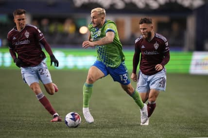 Feb 26, 2023; Seattle, Washington, USA; Seattle Sounders FC forward Jordan Morris (13) dribbles the ball defended by Colorado Rapids defender Keegan Rosenberry (2) in the second half at Lumen Field. Mandatory Credit: Kirby Lee-USA TODAY Sports