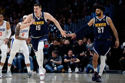 Feb 26, 2023; Denver, Colorado, USA; Denver Nuggets center Nikola Jokic (15) reacts with guard Jamal Murray (27) after a play in the first quarter against the Los Angeles Clippers at Ball Arena. Mandatory Credit: Isaiah J. Downing-USA TODAY Sports