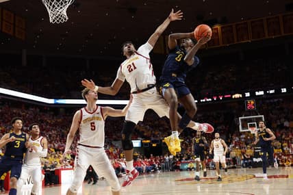 Feb 27, 2023; Ames, Iowa, USA; Iowa State Cyclones center Osun Osunniyi (21) defends the shot from West Virginia Mountaineers guard Kedrian Johnson (0) during the first half at James H. Hilton Coliseum. Mandatory Credit: Reese Strickland-USA TODAY Sports