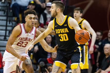 Feb 28, 2023; Bloomington, Indiana, USA; Iowa Hawkeyes guard Connor McCaffery (30) dribbles the ball while Indiana Hoosiers forward Trayce Jackson-Davis (23) defends in the first half at Simon Skjodt Assembly Hall. Mandatory Credit: Trevor Ruszkowski-USA TODAY Sports
