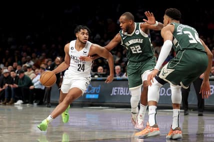 Feb 28, 2023; Brooklyn, New York, USA; Brooklyn Nets guard Cam Thomas (24) controls the ball against Milwaukee Bucks forward Khris Middleton (22) and forward Giannis Antetokounmpo (34) during the first quarter at Barclays Center. Mandatory Credit: Brad Penner-USA TODAY Sports