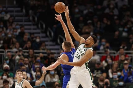 Jan 30, 2022; Milwaukee, Wisconsin, USA;  Milwaukee Bucks forward Giannis Antetokounmpo (34) and Denver Nuggets center Nikola Jokic (15) reach for the ball during the first quarter at Fiserv Forum. Mandatory Credit: Jeff Hanisch-USA TODAY Sports