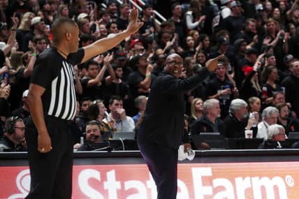 Feb 1, 2022; Lubbock, Texas, USA;  Texas Tech Red Raiders assistant coach Corey Williams gives instructions in front of Big 12 official Keith Kimble during the game against the Texas Longhorns at United Supermarkets Arena. Mandatory Credit: Michael C. Johnson-USA TODAY Sports