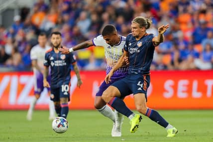 Jun 24, 2022; Cincinnati, Ohio, USA; Orlando City SC midfielder Junior Urso (11) battles for the ball against FC Cincinnati defender Nick Hagglund (4) in the second half at TQL Stadium. Mandatory Credit: Katie Stratman-USA TODAY Sports