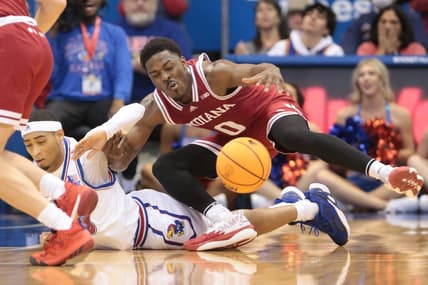 Indiana super-senior Xavier Johnson (0) trips on Kansas redshirt junior guard Dajuan Harris Jr. (3) during the first half of Saturday's game inside Allen Fieldhouse.

Syndication The Topeka Capital Journal