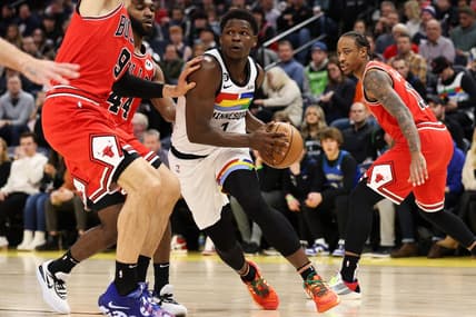Dec 18, 2022; Minneapolis, Minnesota, USA; Minnesota Timberwolves guard Anthony Edwards (1) dribbles while Chicago Bulls center Nikola Vucevic (9) defends during the first quarter at Target Center. Mandatory Credit: Matt Krohn-USA TODAY Sports
