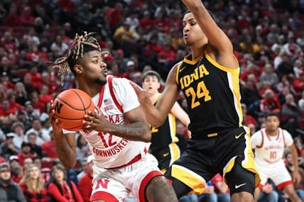 Dec 29, 2022; Lincoln, Nebraska, USA;  Nebraska Cornhuskers guard Denim Dawson (12) attempts a shot against Iowa Hawkeyes forward Kris Murray (24) in the first half at Pinnacle Bank Arena. Mandatory Credit: Steven Branscombe-USA TODAY Sports