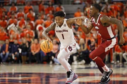 Jan 7, 2023; Auburn, Alabama, USA;  Auburn Tigers guard Wendell Green Jr. (1) moves the ball against Arkansas Razorbacks guard Davonte Davis (4) during the second half at Neville Arena. Mandatory Credit: John Reed-USA TODAY Sports