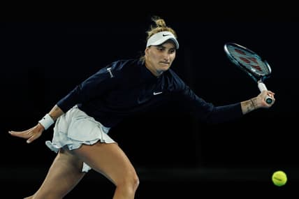 Jan 19, 2023; Melbourne, Victoria, Australia;  Marketa Vondrousova of the Czech Republic hits a shot against Ons Jabeur of Tunisia on day four of the 2023 Australian Open tennis tournament at Melbourne Park. Mandatory Credit: Mike Frey-USA TODAY Sports